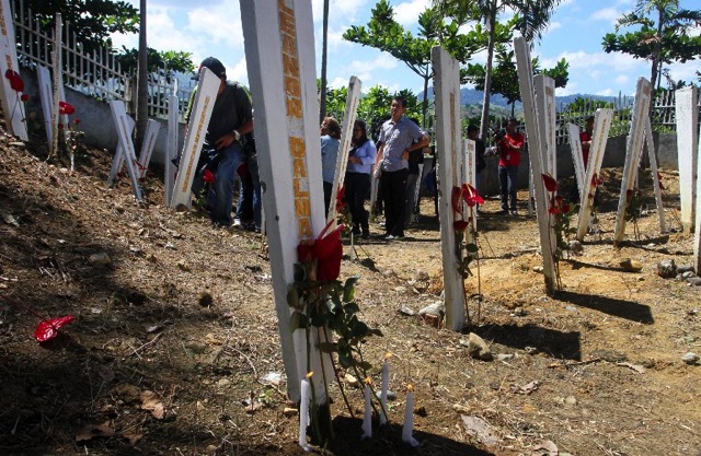 Relatives and supporters of victims of the infamous massacre visit the site where 58 people were killed in Ampatuan town, Maguindanao province, in Mindanao. Photo by Mark Navales/AFP  