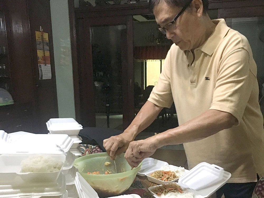 August Romero, a retired engineer, and his wife Imelda, voluntarily feed the poor near their residence in Quezon City three times a week, with home cooked, good food.  They have been  doing this for last five years. (Photo by Santosh Digal)    
