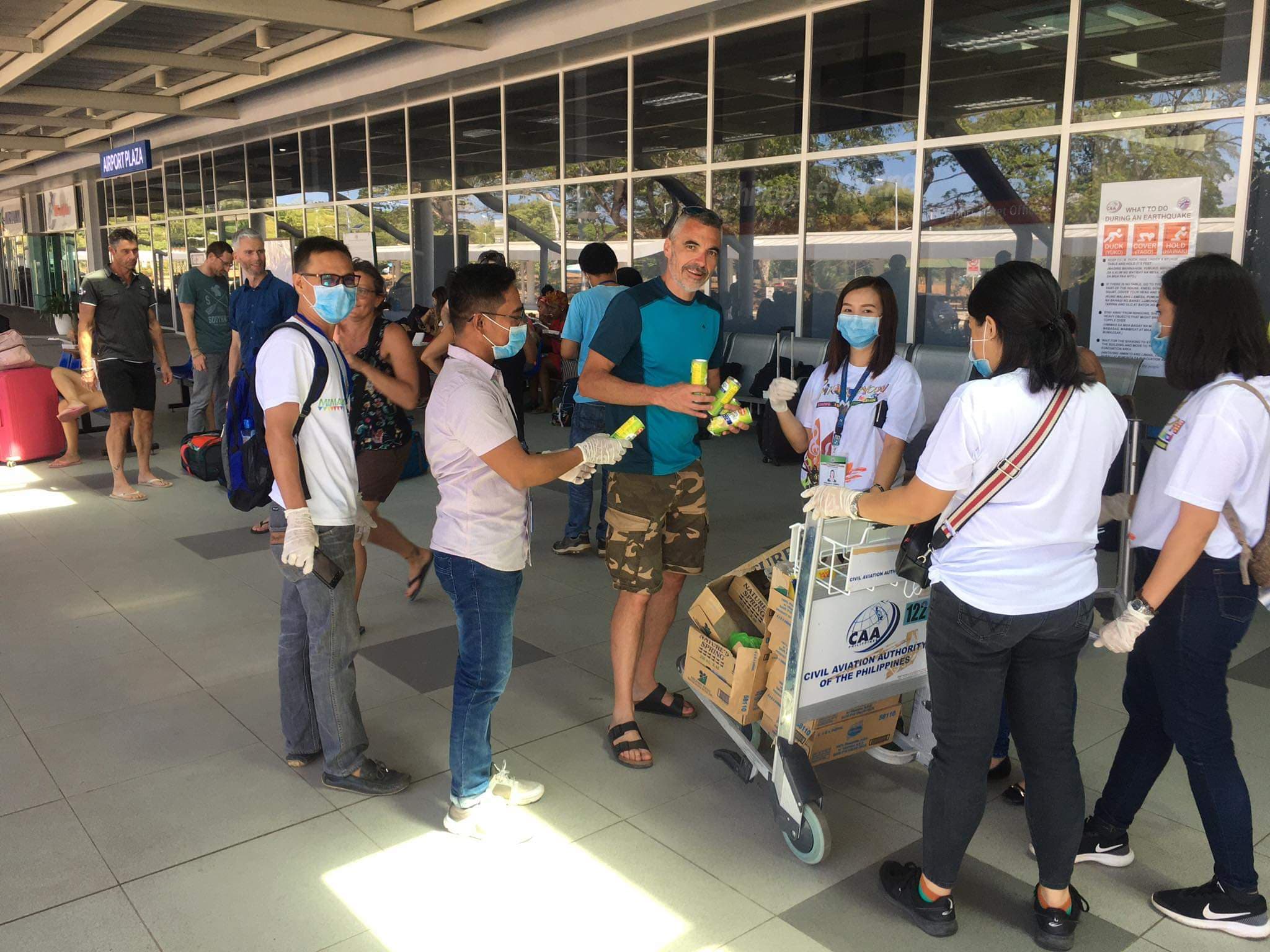 Tourists and assisting tourism officers at the Puerto Princesa International Airport. (Photo courtesy of DOT Mimaropa)   