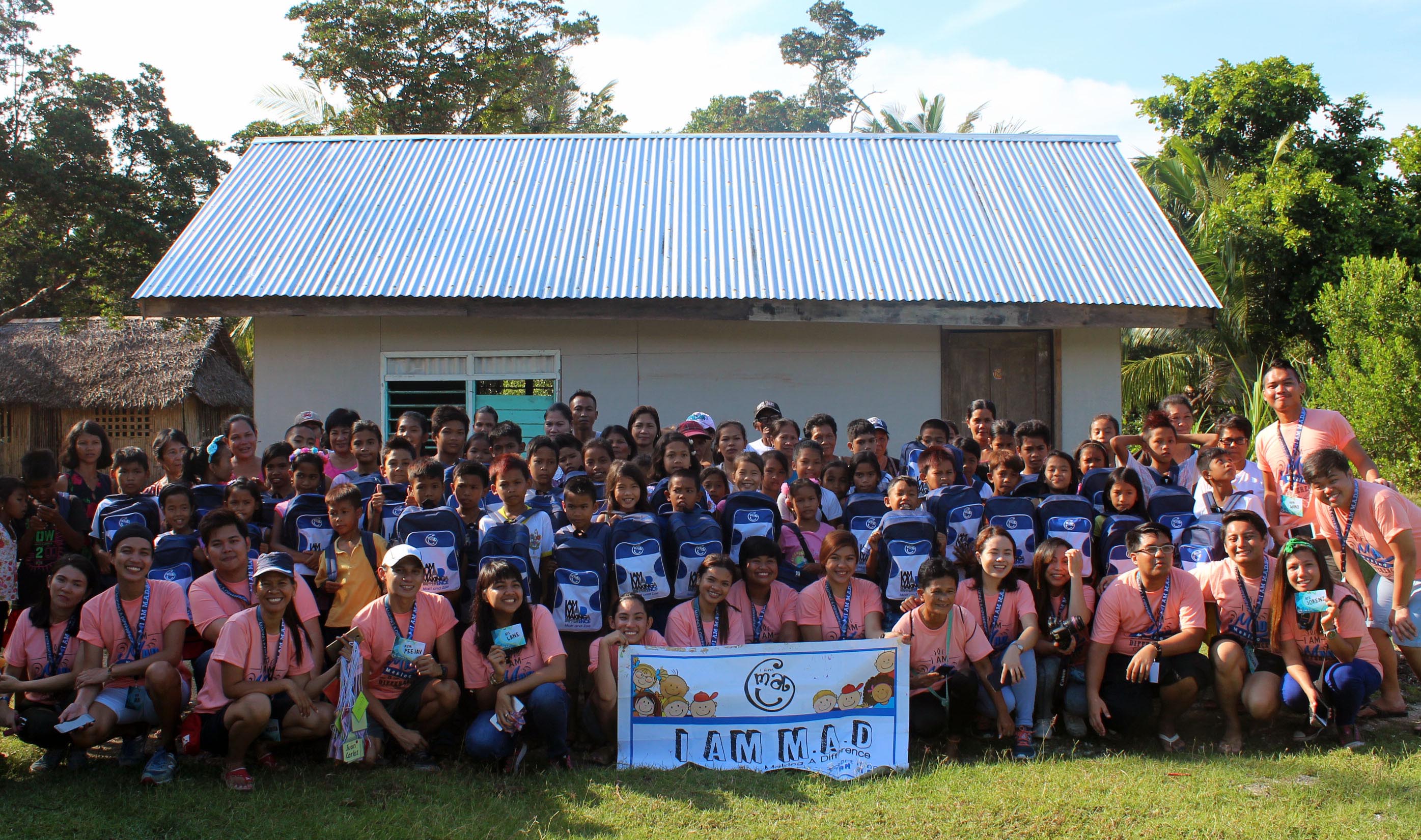 Firing up the spirit of volunteerism while traveling. I am M.A.D. (Making A Difference) conquered the town of Magdiwang, Sibuyan Island, Romblon for its 32nd MAD Camp area at Tomas and Maria Maglaya Memorial School. Millenial volunteers together with the beneficiaries and their parents pose for a souvenir photo.