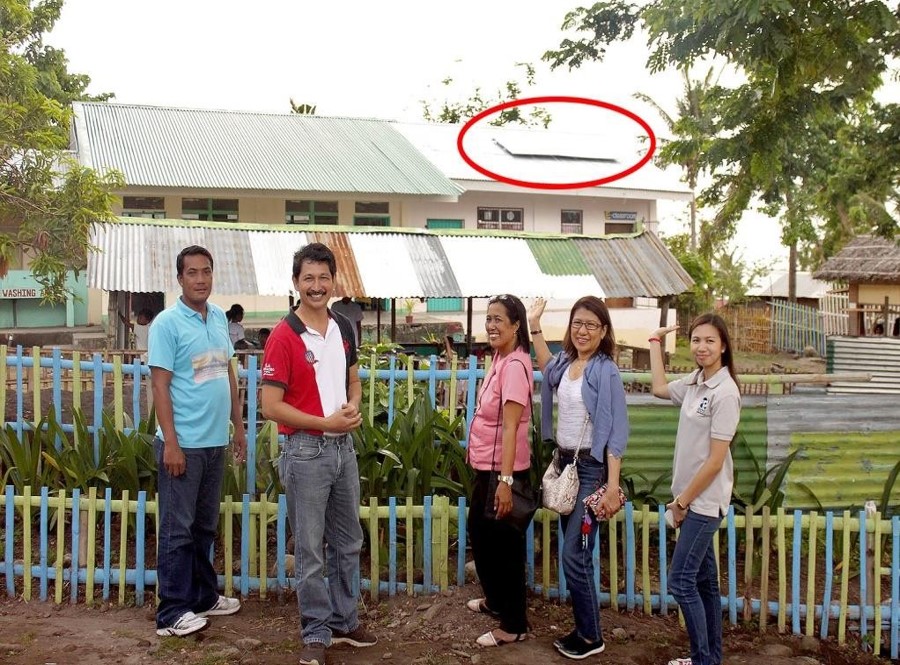 Ms. Concepcion Camua, Principal of Binunga Elementary School (center), shows the Solar Energy System installed in one of the schools in Brgy. Binunga, Buenavista, Marinduque (CEST Area)